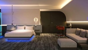 A modern bedroom with a bed, a sofa, a desk, and a wardrobe. - CapsuleTransit MAX - Terminal 2 (Sepang)