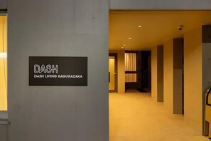 A hallway with a sign reading 'DASH DASH LIVING KAGURAZAKI'. - Dash Living Kagurazaka (Tokyo)