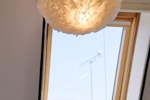 A ceiling with a textured, spherical light fixture. - Mi-Loft Shibuya (Tokyo)