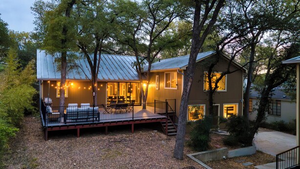 A house with a deck, outdoor seating, and string lights. - Sleeps 18! Game Room, Deck w/ Firepit, 5BDR, Casita | Cedar & Stone by AvantStay (Austin)