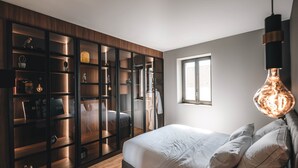 A bedroom with a bed, a wardrobe, and a window. - Exceptional Victoire apartment (Épinal)
