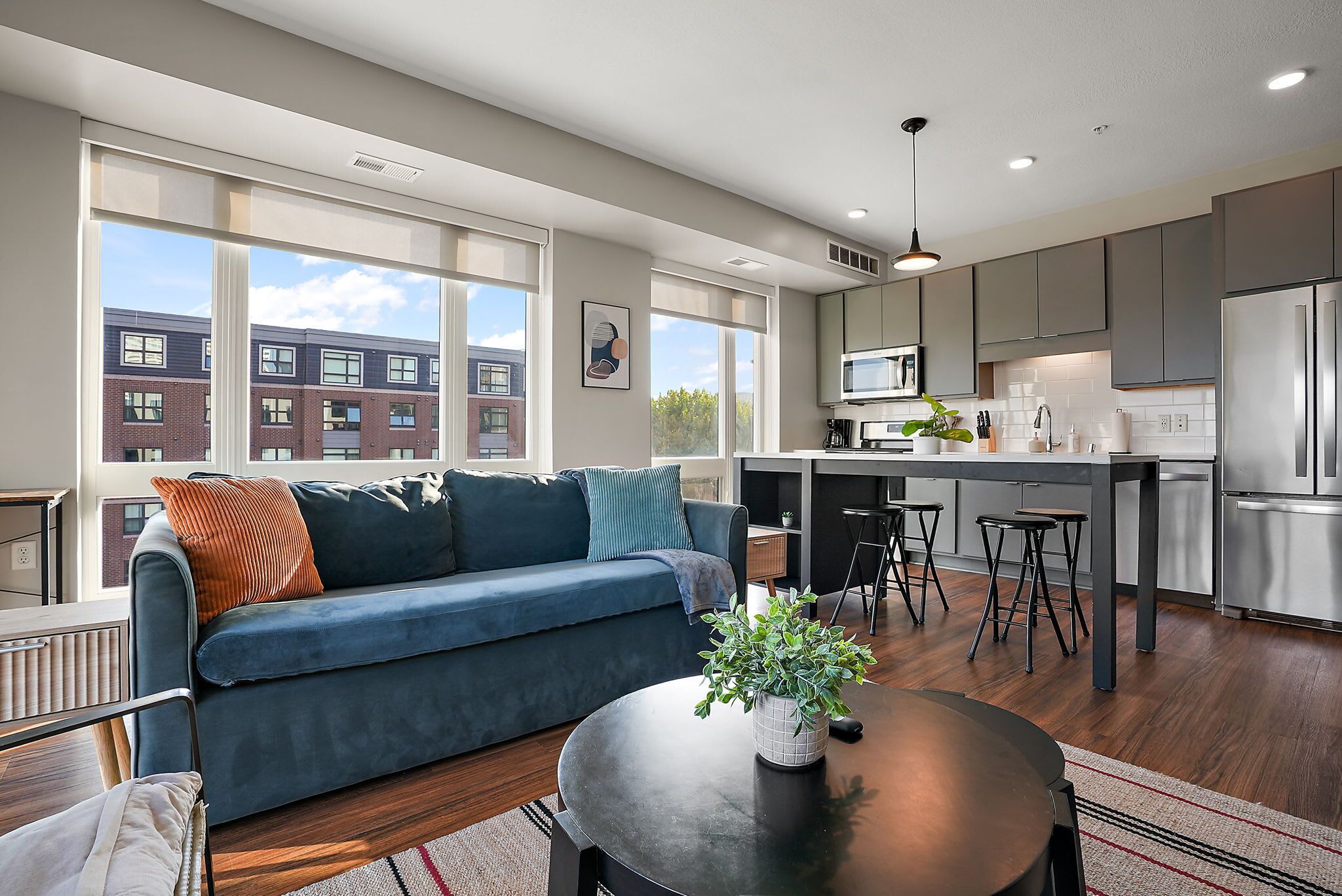 A modern apartment with a living room, kitchen, and dining area.