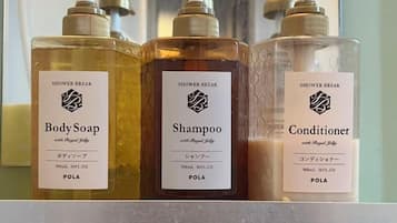 Three bottles of shower break products on a shelf.