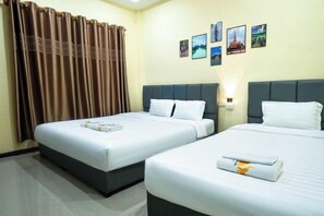 A hotel room with two beds, a curtain, a wall-mounted light, and several framed pictures. - Yula Hotel Thatluang (Vientiane)