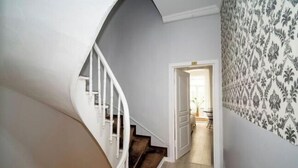 A staircase leading to a room with patterned wallpaper and a view into another room. - New Life Taksim Hotel (Istanbul)