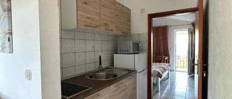 Fridge, microwave, stovetop, dining tables