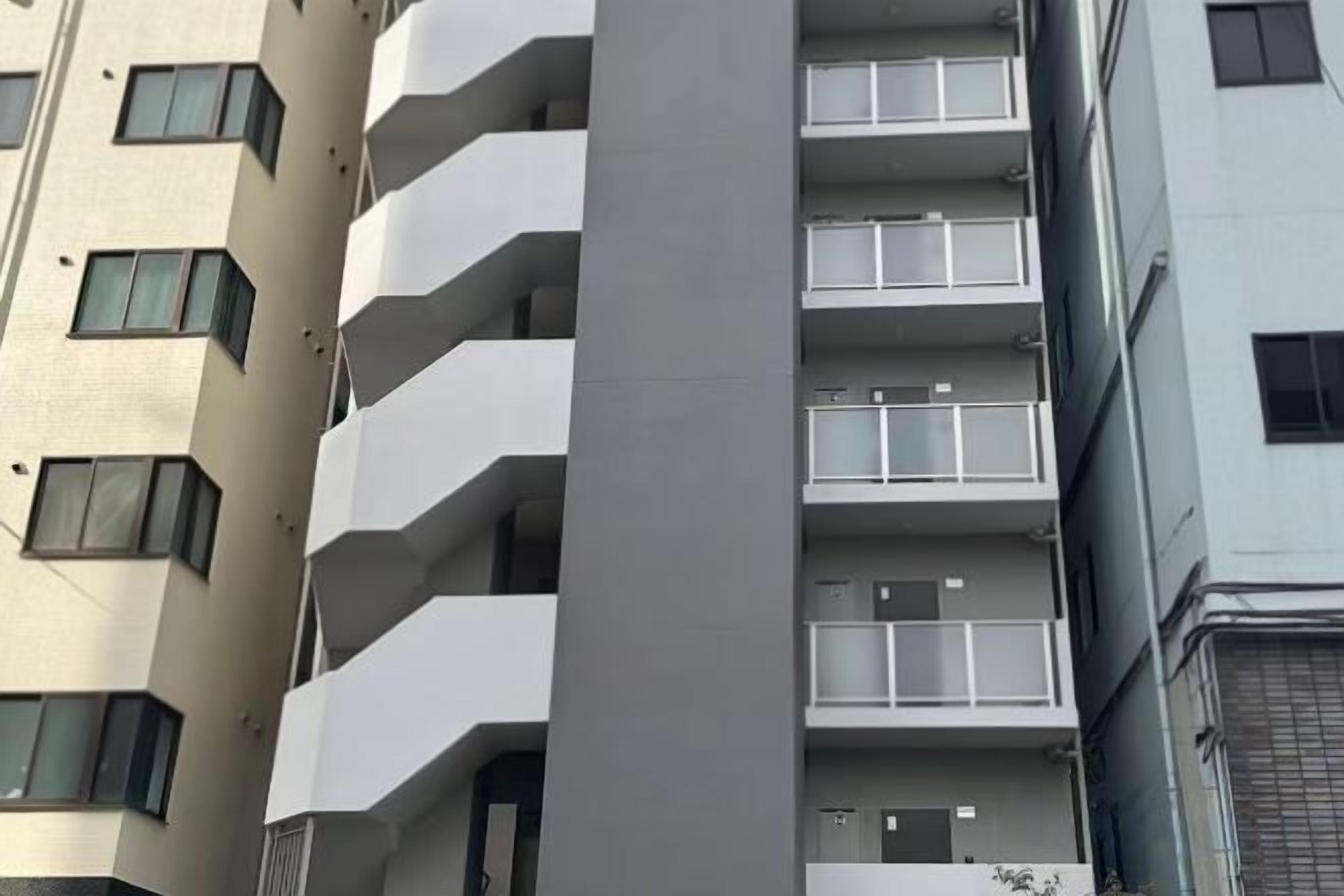 A multi-story building with balconies and windows.