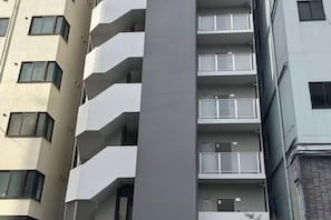 A multi-story building with balconies and windows.