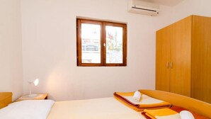 A bedroom with a bed, a nightstand, a lamp, a window, and a wardrobe. - Guest House Sobra 38 - Double Room 1 (Sobra)