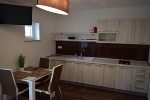 Fridge, stovetop, toaster, dining tables