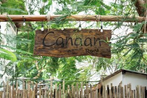 A wooden sign with the text 'Canair Resort' hanging amidst greenery. - Canaan Beach Home (Phu Quoc Island)