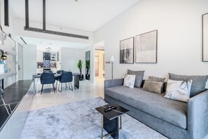 Deluxe Apartment, Balcony, City View | Living area | 55-inch Smart TV with digital channels