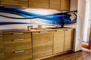 Fridge, stovetop, dishwasher, coffee/tea maker