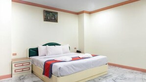 A hotel room with a bed, a nightstand, and a wall-mounted phone. - 75 Paradise Lane Managed by Loft Group (Bangkok)