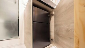 A corner of a room with a wooden cabinet and a frosted glass door. - Retaw Hills Waseda (Tokyo)