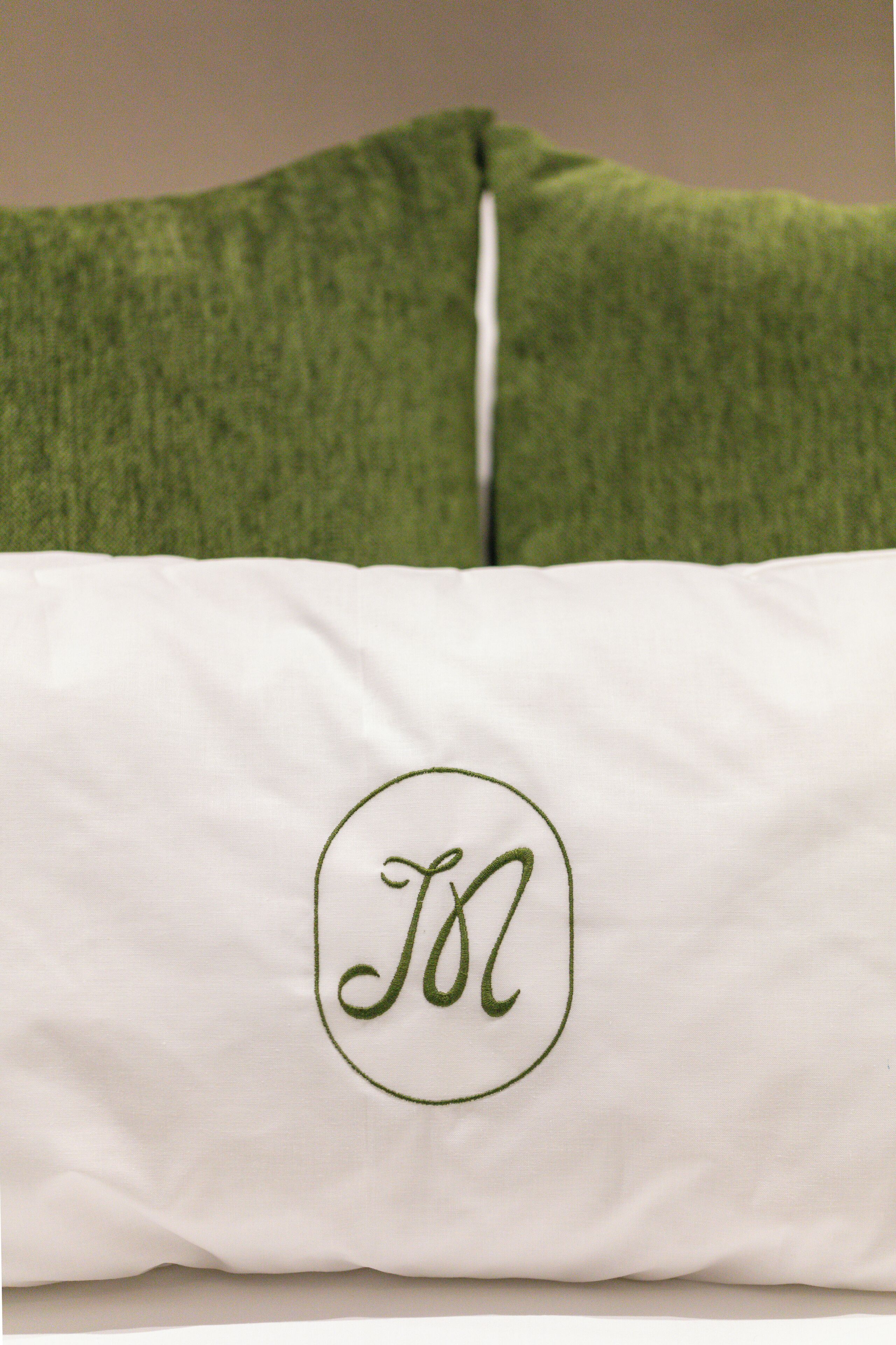 A pillow with a white fabric and a green fabric.