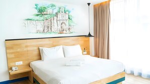 A hotel room with a wooden bed, white bedding, a painting of a building on the wall, a bedside table with a phone, and a window with curtains. - 96 Boutique Hotel (Melaka)