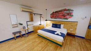 A hotel room with a bed, bedside table, mirror, air conditioning unit, and a wall painting. - 96 Boutique Hotel (Melaka)