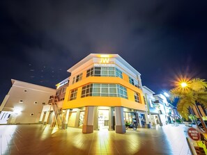 A modern hotel with a prominent 'JW' sign, a central entrance, and a well-lit outdoor area. - 96 Boutique Hotel (Melaka)