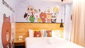 A hotel room with a large cartoon character mural on the wall, a wooden headboard, and a bed with three pillows, one of which has a bear design. - 96 Boutique Hotel (Melaka)