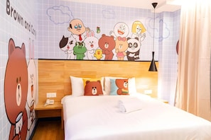 A hotel room with a large cartoon character mural on the wall, a wooden headboard, and a bed with three pillows, one of which has a bear design. - 96 Boutique Hotel (Melaka)