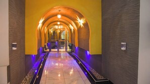 A hallway with a yellow and brown color scheme, leading to a glass door entrance. - Golden Palace Hotel Eldoret (Eldoret)