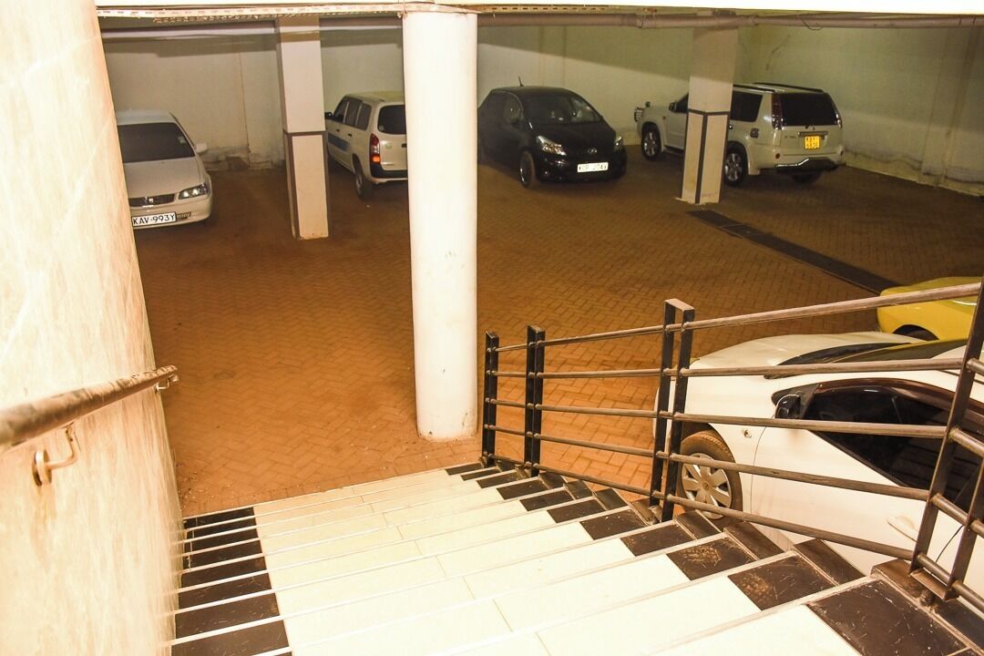 A multi-level parking garage with several cars parked on different levels.