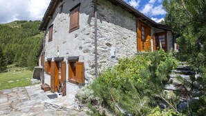 A stone house with wooden shutters, a stone staircase, and a garden with pine trees. - Beautiful private villa for 7 guests with WIFI, TV and pets allowed (Casone)