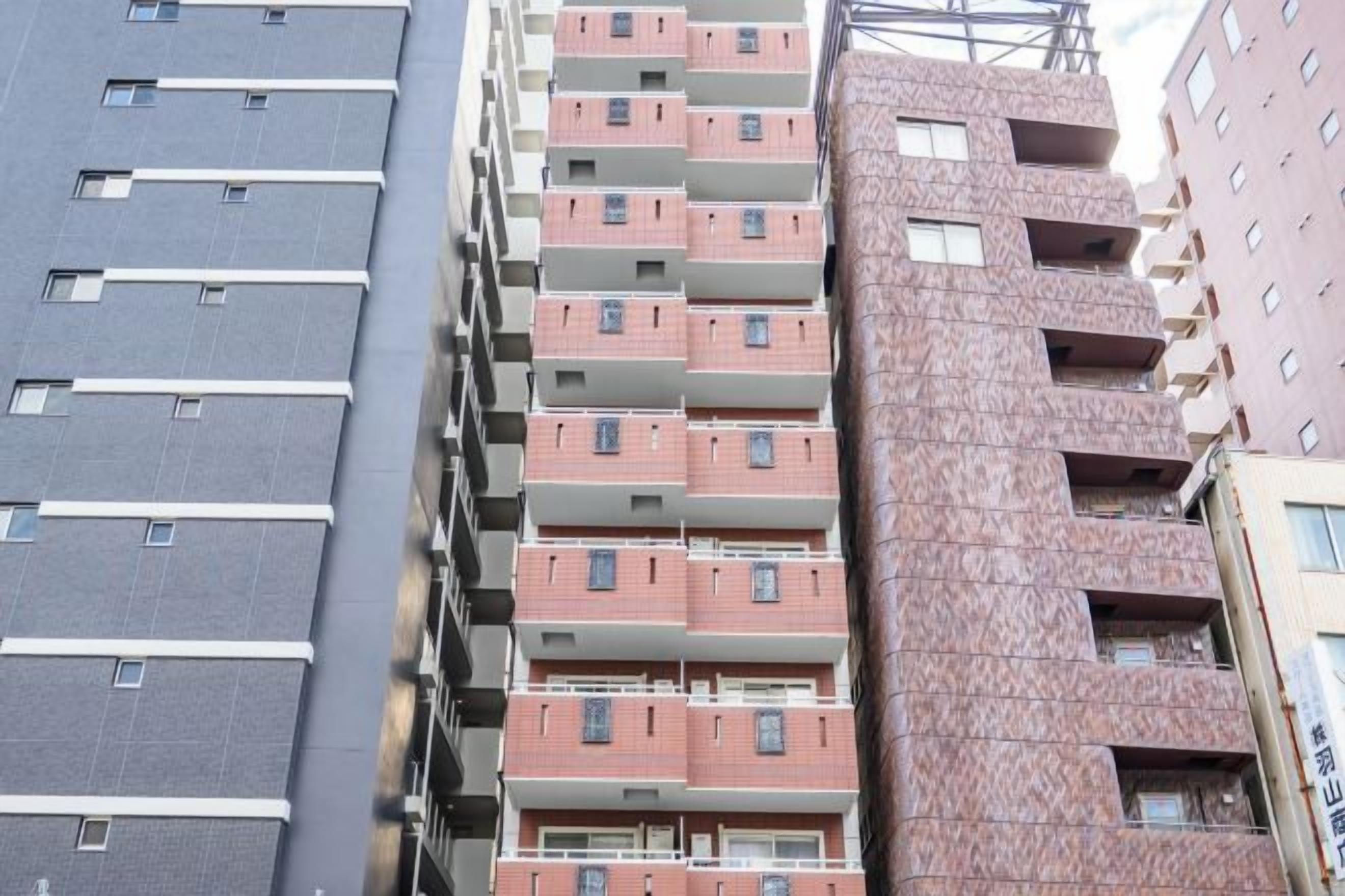 A multi-story building with balconies and windows.