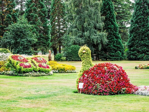A garden with topiary sculptures and flower beds.