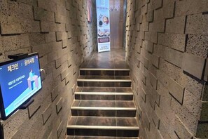 A staircase with a digital screen displaying information. - Carlton Hotel (Incheon)