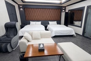 A modern hotel room with two beds, a massage chair, a sofa, and a small table. - Carlton Hotel (Incheon)