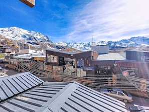 A mountainous town with a prominent building labeled "INTERSPORT" and a sign for "LA FERME DE THORENS."