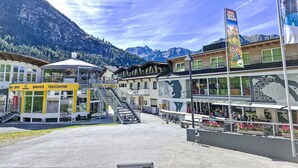 A ski resort building with a service center, bar, and a staircase leading to upper floors.