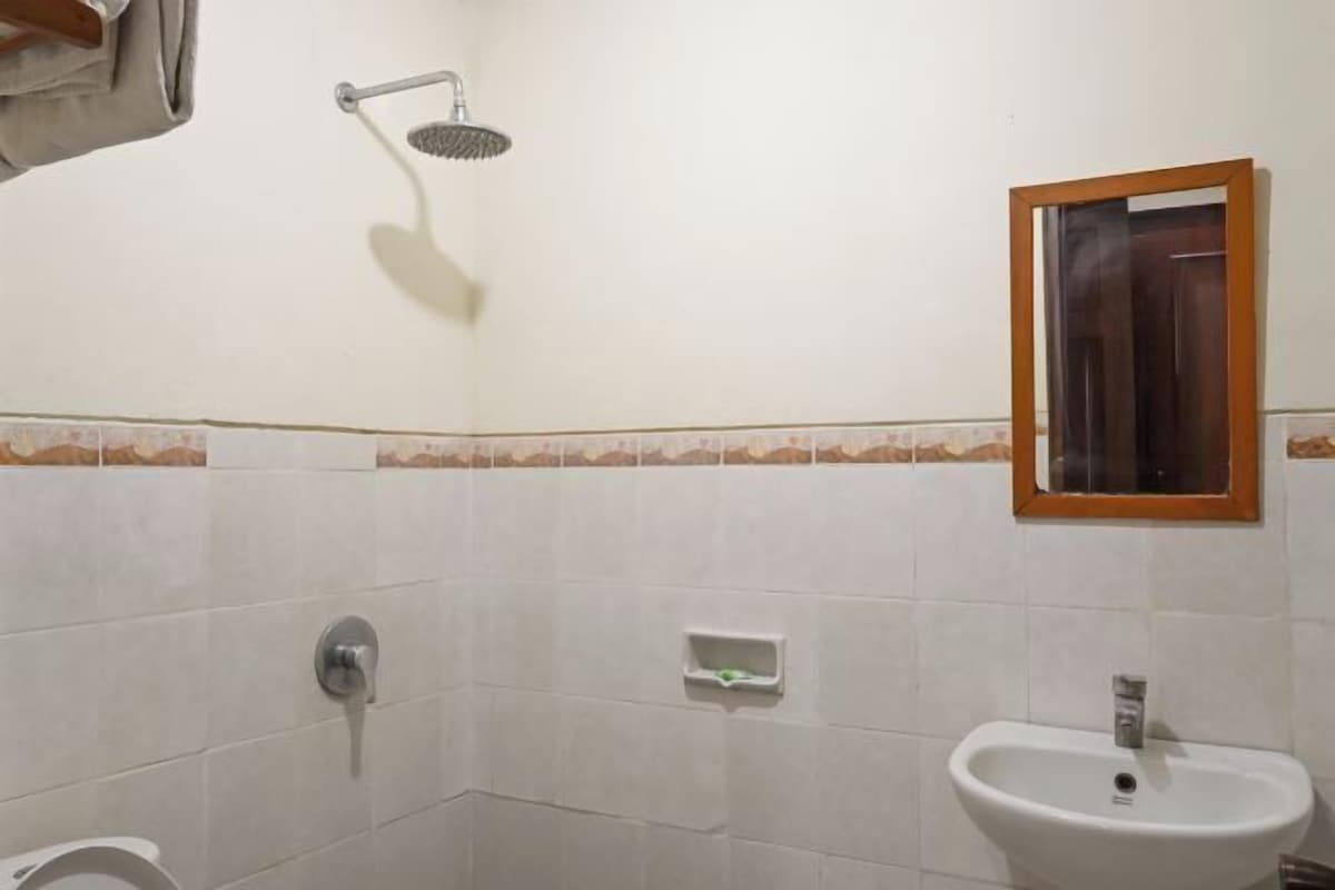 A bathroom with a shower, sink, and toilet.