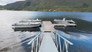 A dock with boats, a wooden pier, and a mountainous backdrop. - Spacious House, With Boat, in Beautiful Landscape (Aure)