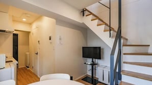A modern hotel room with a bed, a TV, a desk, and a staircase. - Mi-HOTEL ASAKUSA (Tokyo)