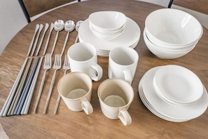 A table set with white dinnerware, including plates, bowls, cups, and cutlery. - Mi-HOTEL ASAKUSA (Tokyo)