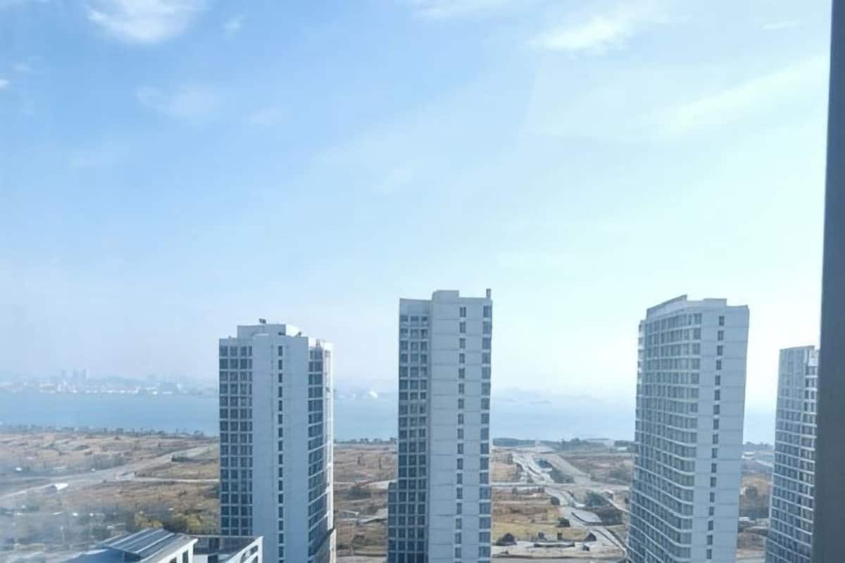 Three high-rise buildings with a clear view of the surrounding landscape.