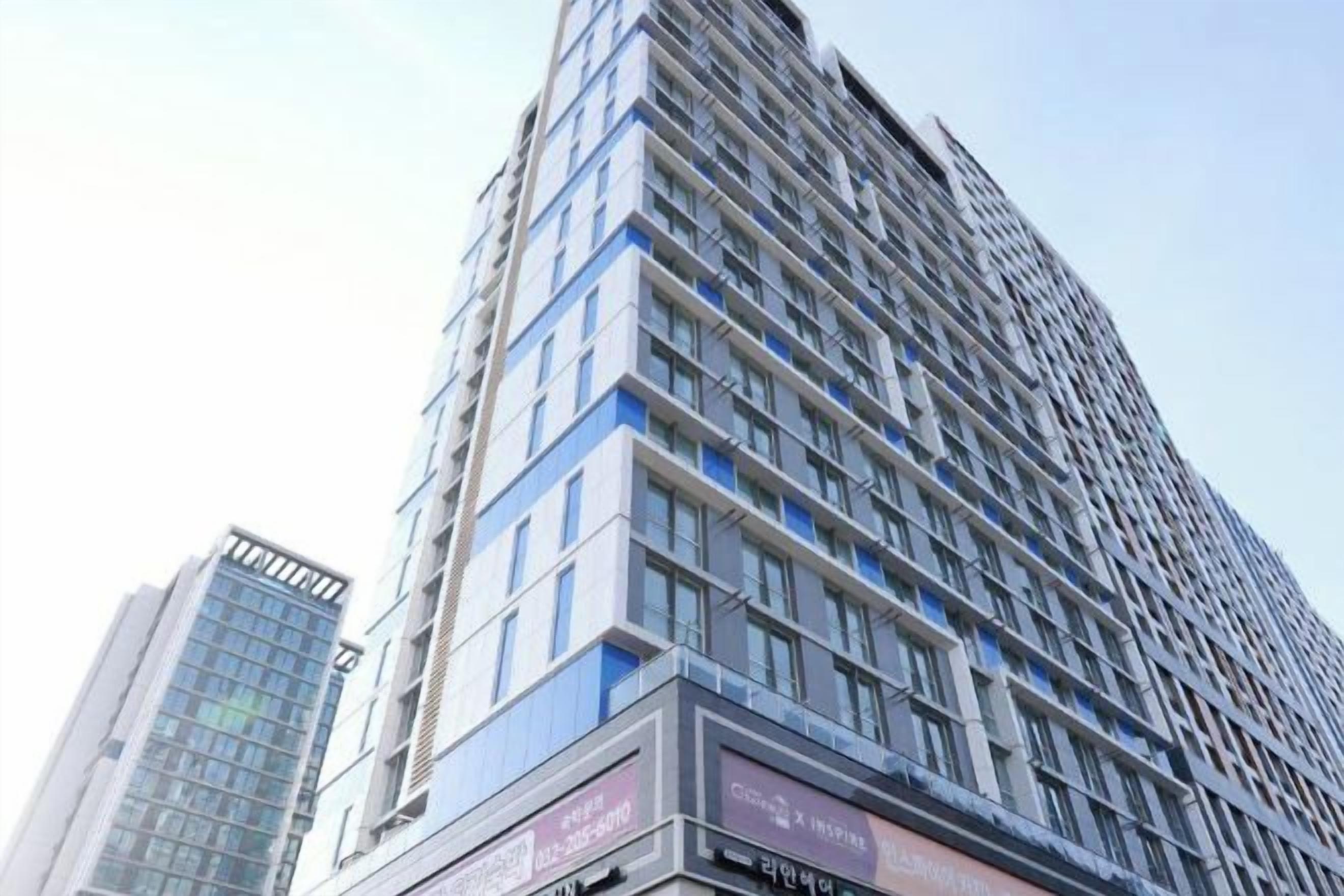 A high-rise building with multiple floors, large windows, and a modern architectural design.
