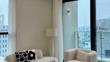 Luxury Apartment, 2 Bedrooms, Balcony | Living area | 85-inch Smart TV with digital channels, Netflix, streaming services