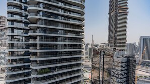 A modern high-rise building with multiple balconies and a curved facade. - DAMAC Maison Mall Residences - Downtown (Dubai)