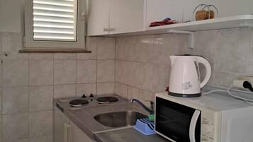 Fridge, microwave, stovetop, dining table