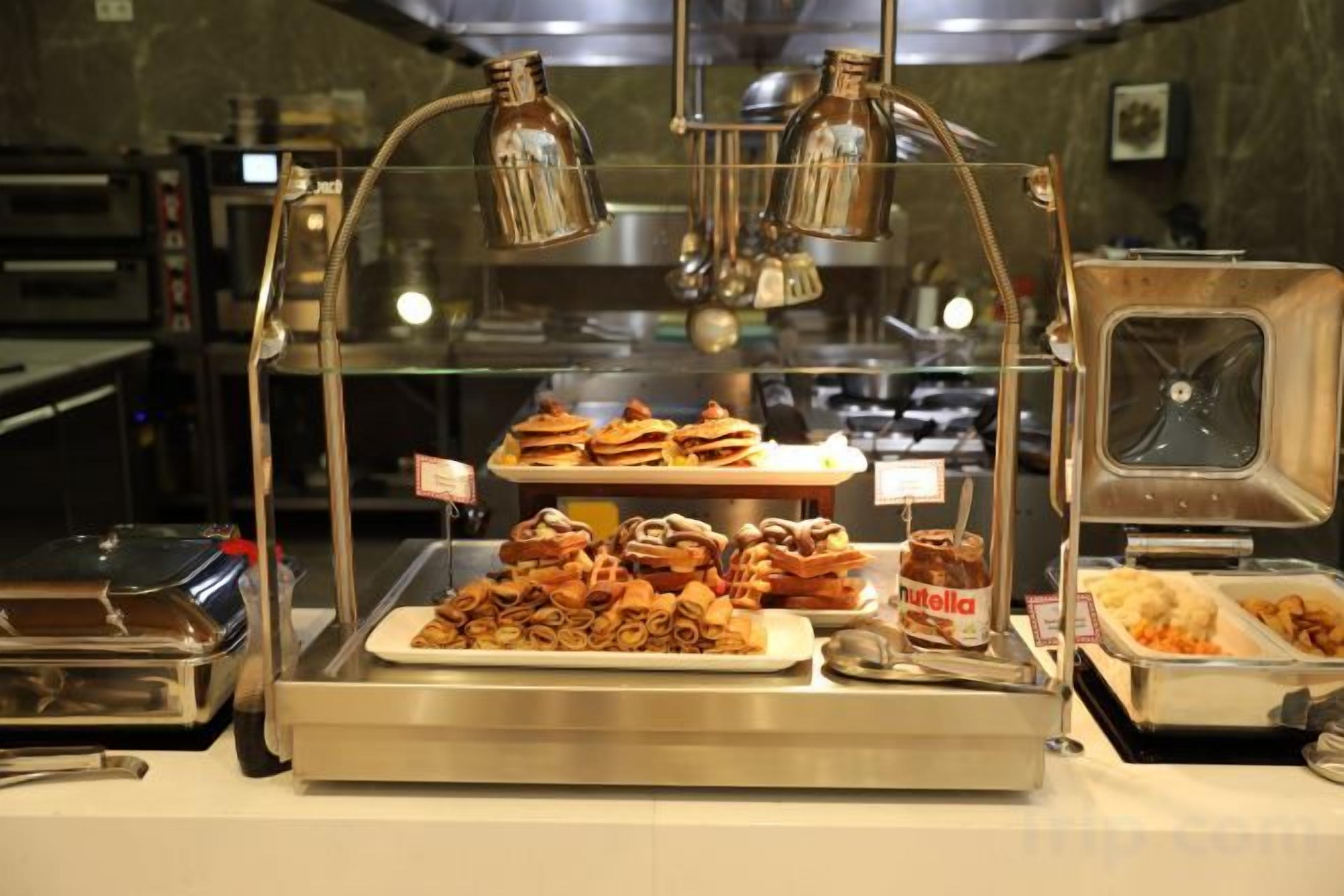 A buffet with various food items and a Nutella jar.
