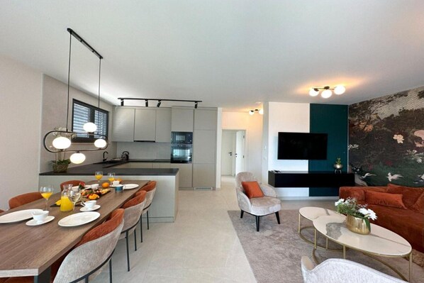 A modern living room with a sofa, coffee table, and a TV.