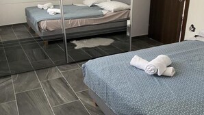 A hotel room with a bed, a mirror, and a door. - Apartments Stone House Murter - Two Bedroom Apartment (Murter)