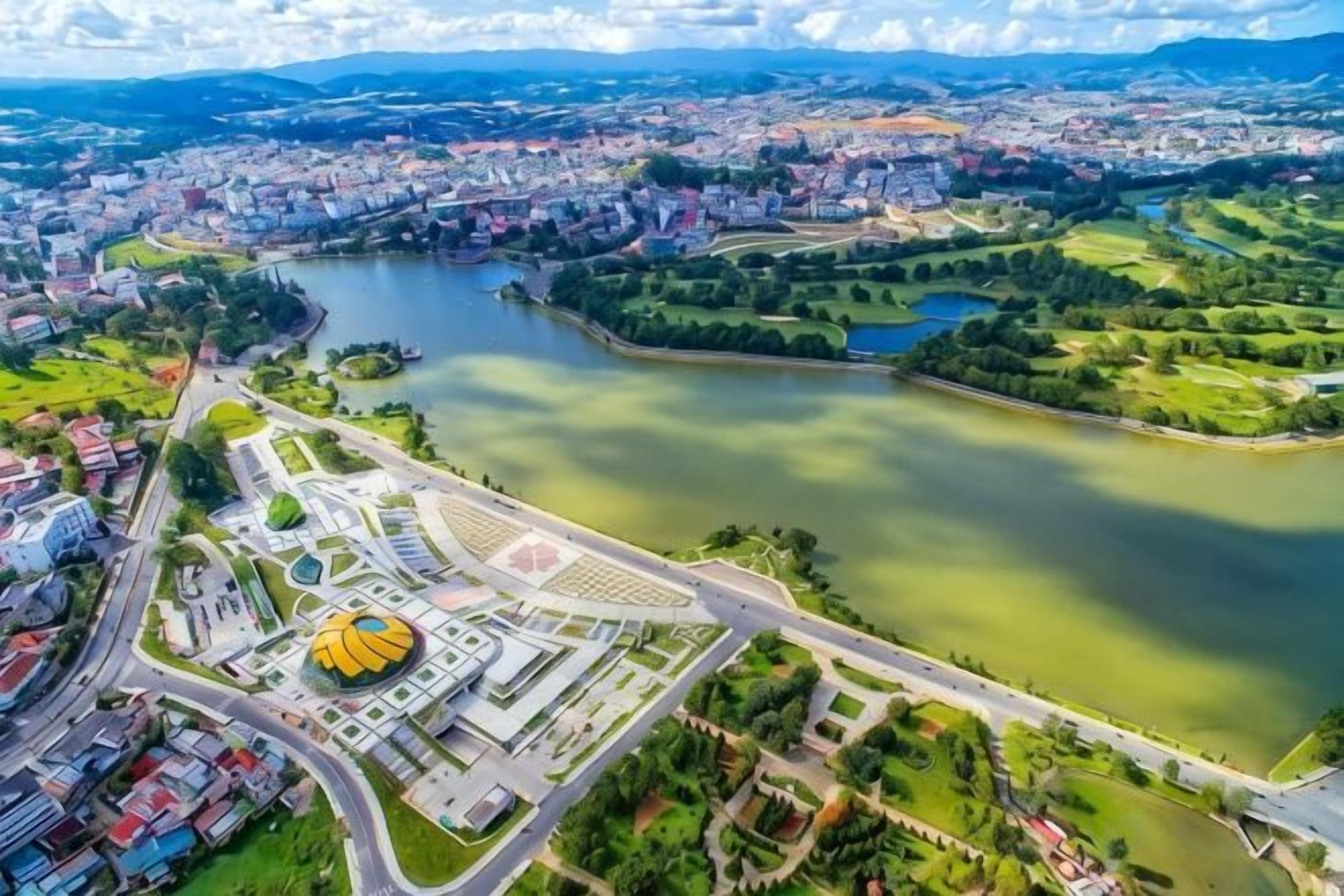 An aerial view of a city with a river, a park, and a stadium.