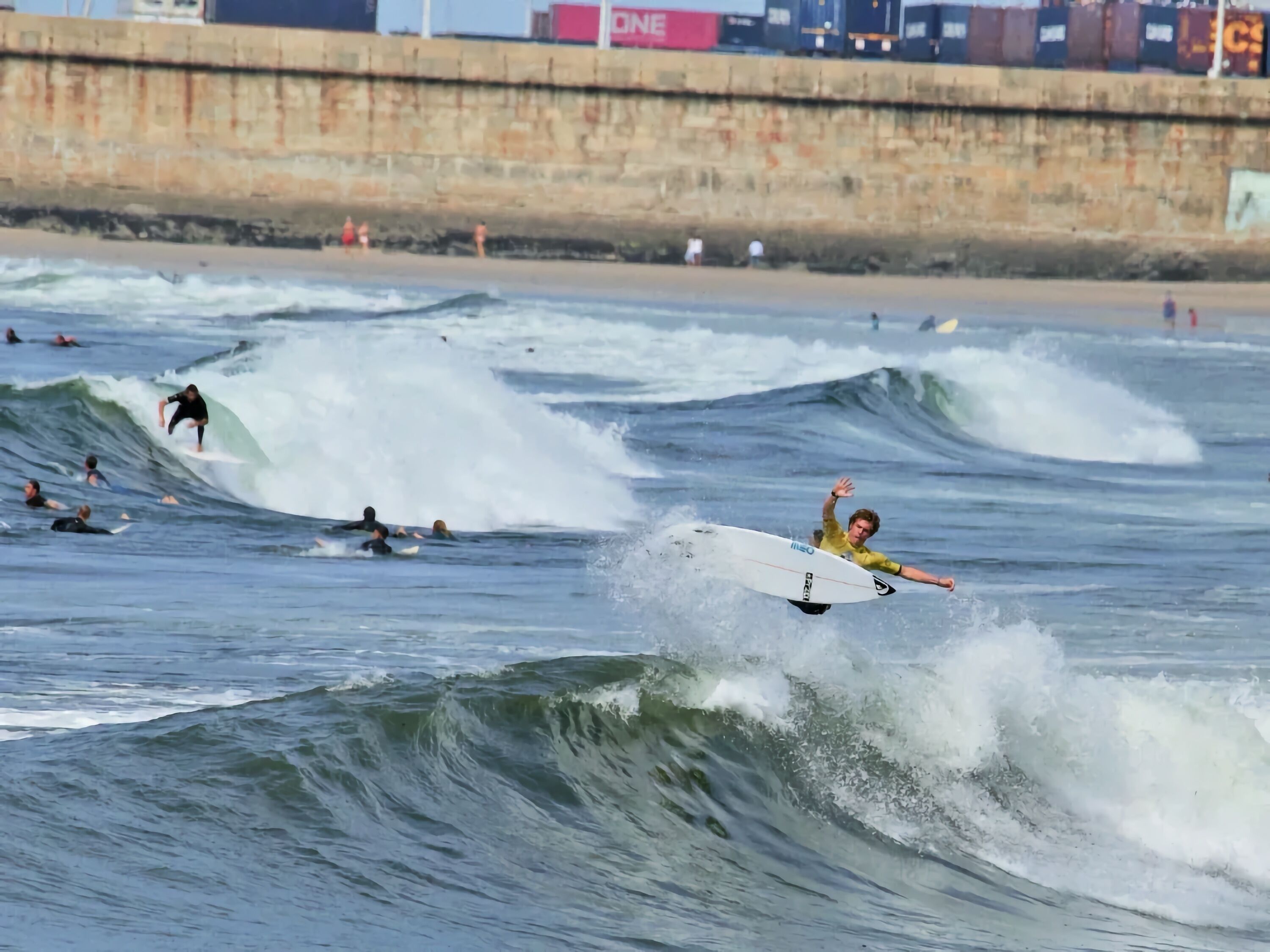 A beach scene with surfers and waves.