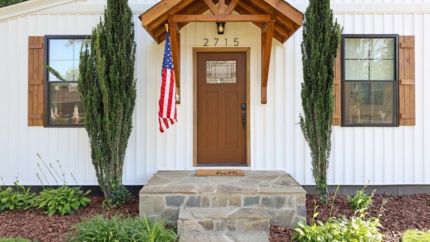 A white building with a brown door, number 2715, and an American flag. - Luxury 3BR Getaway • Steps From the River access (Bassett)