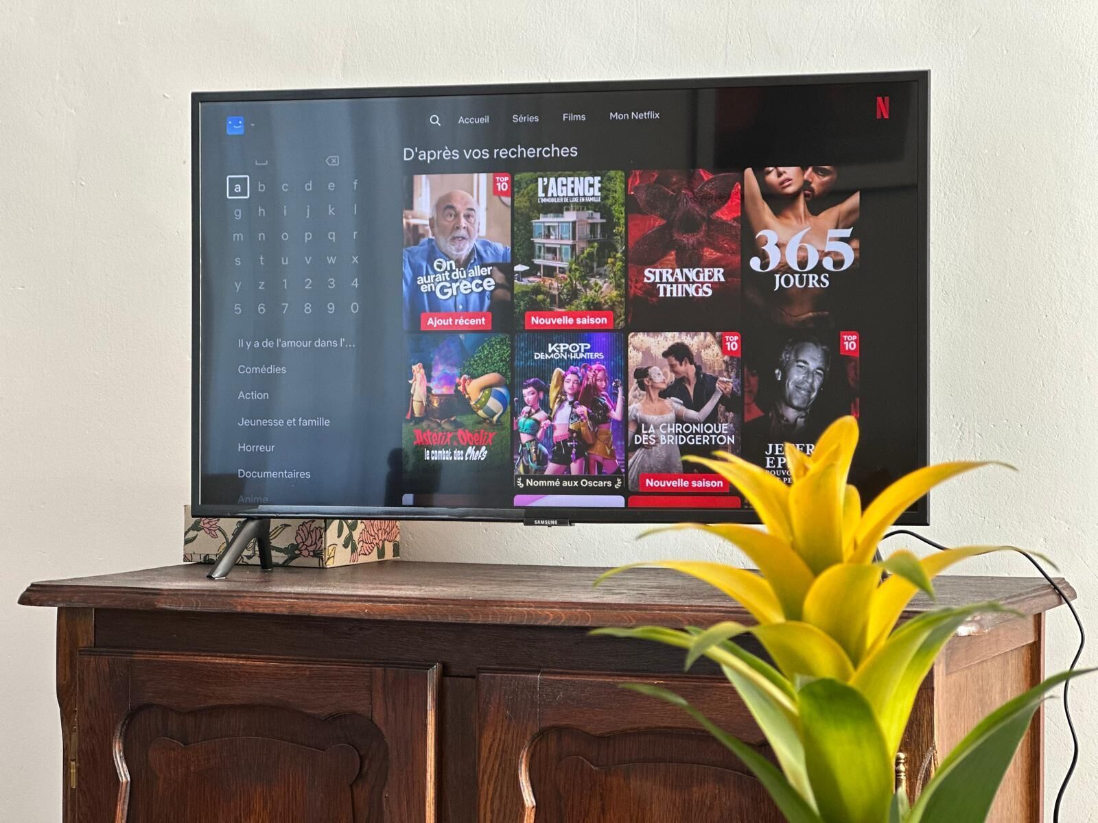 A television displaying a streaming service interface with various categories and top shows.